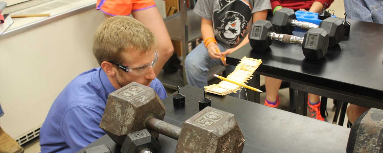 Student testing makeshift airplane in lab