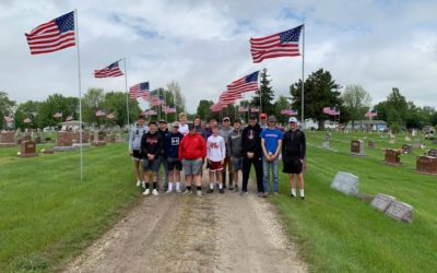Members of Baseball Team Help Place Flags for Memorial Day
